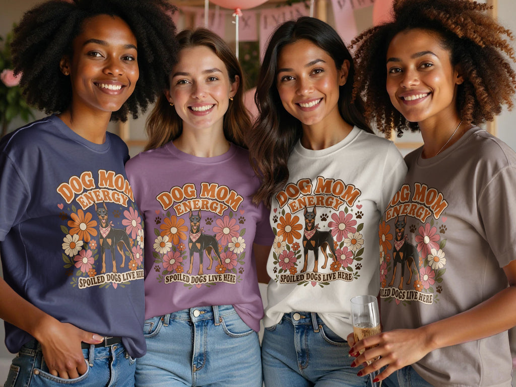 Four women wear graphic tees with "Dog Mom Energy" and a Doberman dog graphic.
