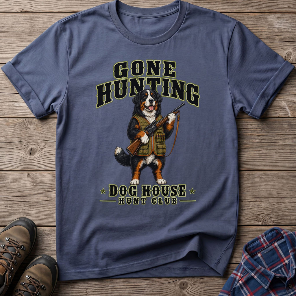 Bernese Mountain Dog wearing hunting vest holding rifle, "Gone Hunting Dog House Hunt Club" text.