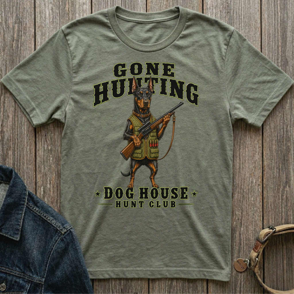 T-shirt with Doberman holding rifle, text reads "Gone Hunting Dog House Hunt Club".