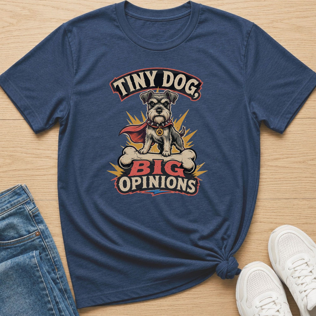 Navy t-shirt with a schnauzer wearing a cape and cape, sitting on a bone, with text "Tiny Dog, Big Opinions."