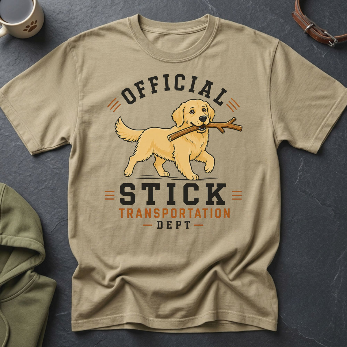 T-shirt with graphic of golden retriever carrying stick, text "Official Stick Transportation Dept".