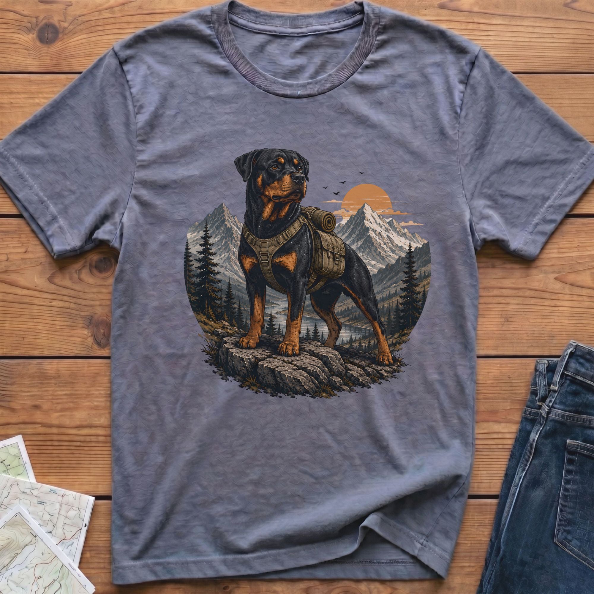 T-shirt with Rottweiler wearing backpack in mountain landscape art.