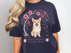 Navy t-shirt with a corgi sitting under a cherry blossom tree.