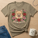 Pomeranian dog with roses and banner reading "Loyal Love Blooms" on a tan t-shirt.