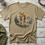 Golden Retriever wearing a backpack stands on a rock overlooking a mountain lake landscape.