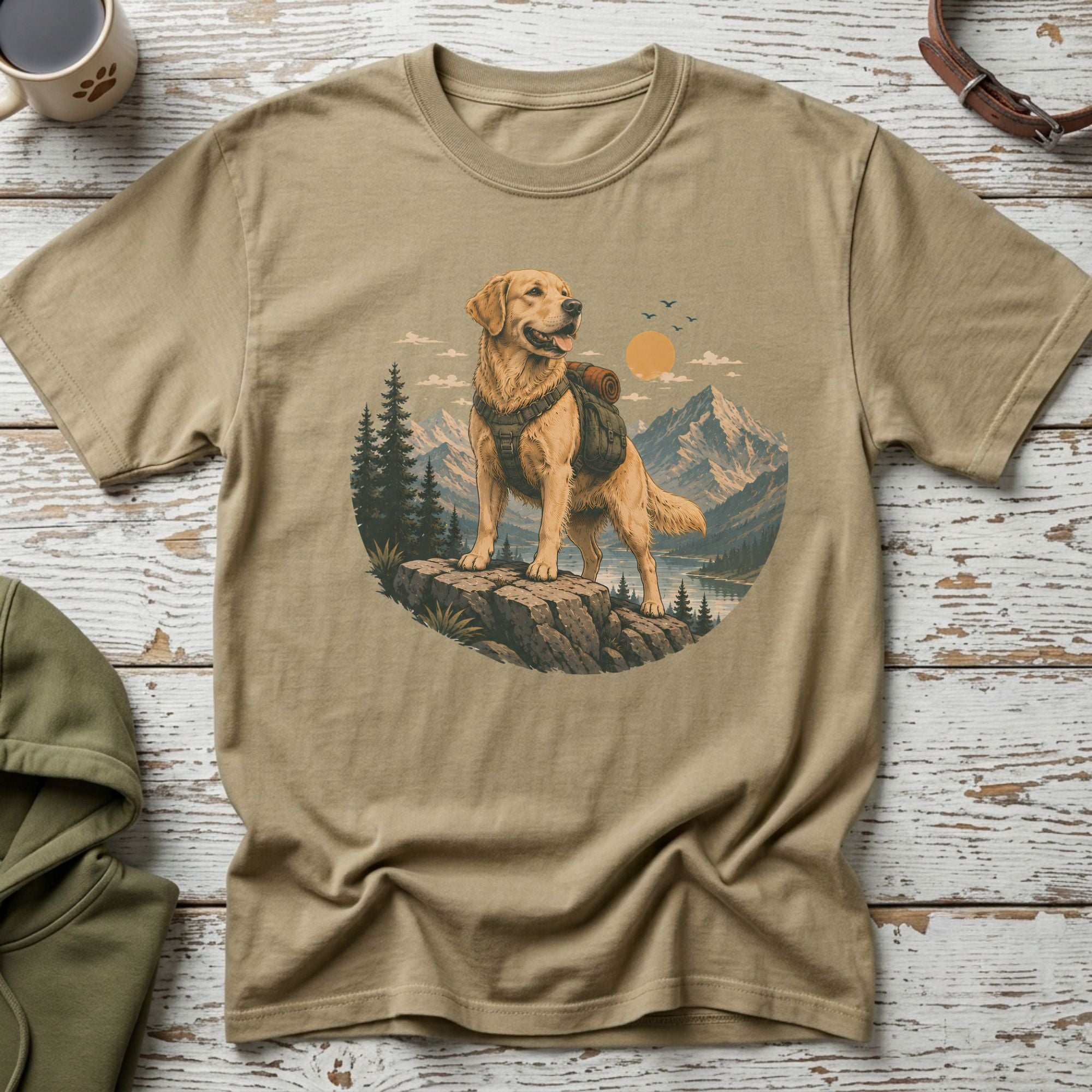 Golden Retriever wearing a backpack stands on a rock overlooking a mountain lake landscape.