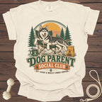 Cream t-shirt with a husky relaxing in a camping chair with text "Dog Parent Social Club".