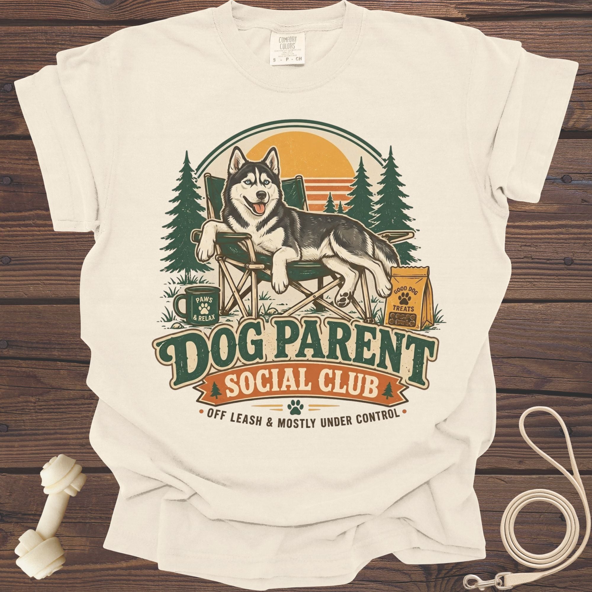 Cream t-shirt with a husky relaxing in a camping chair with text "Dog Parent Social Club".