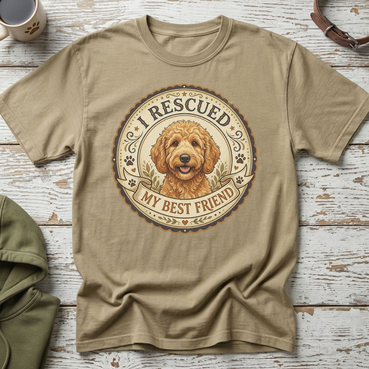 Tan t-shirt with circular graphic featuring a doodle dog and text "I Rescued My Best Friend."