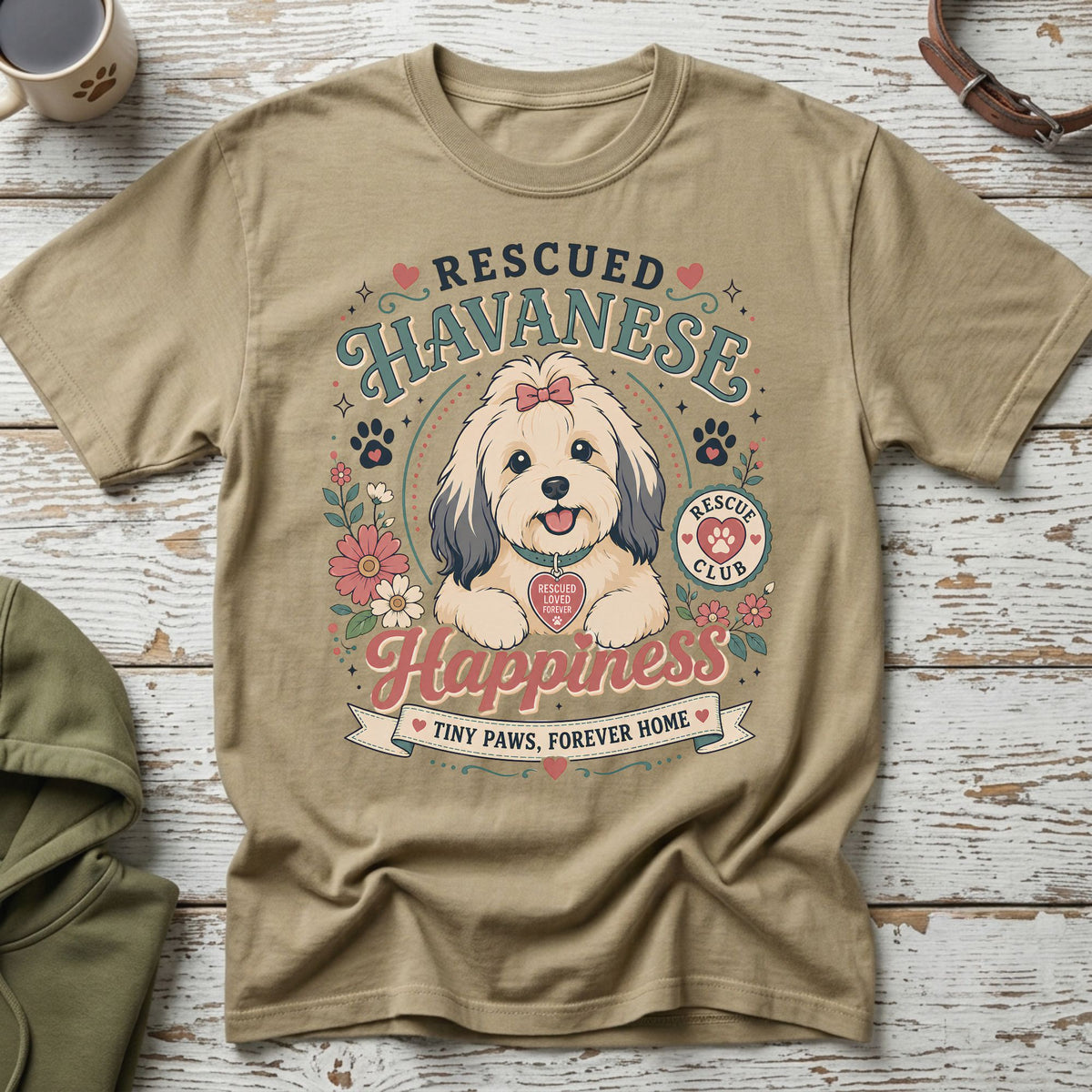 Rescued Havanese happiness with tiny paws, forever home slogan on t-shirt.