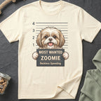 Cream t-shirt with graphic of a Shih Tzu in a mugshot holding a sign reading "Most Wanted Zoomie Reckless Speeding".