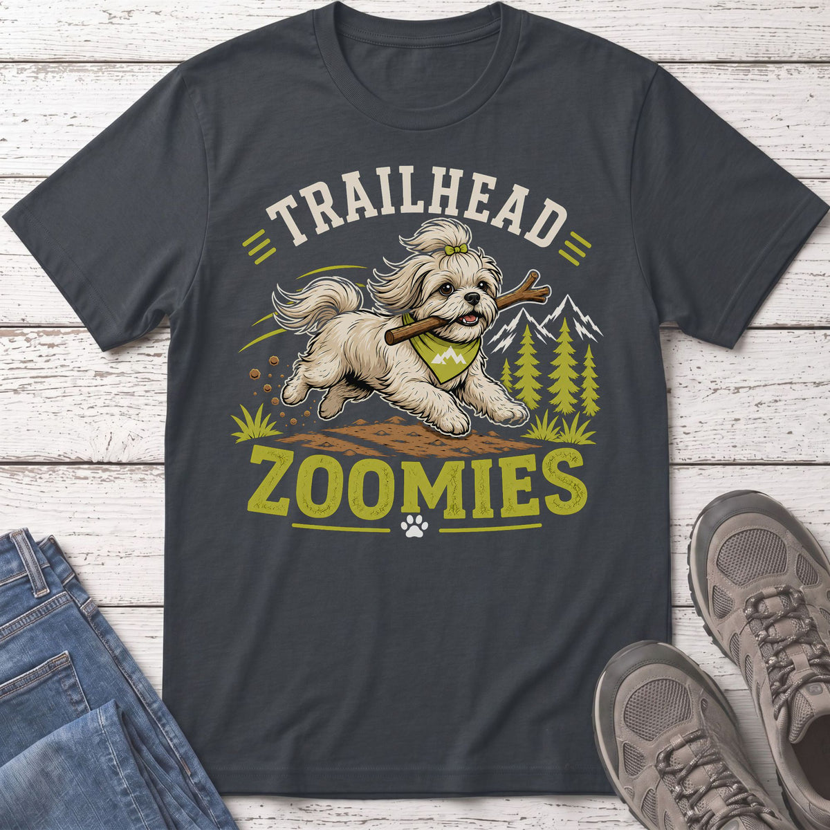 "Trailhead Zoomies" text above a dog running with a stick, mountains and trees.