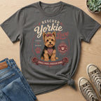 Rescued Yorkie with "Small Paws, Forever Home" text and a bow.