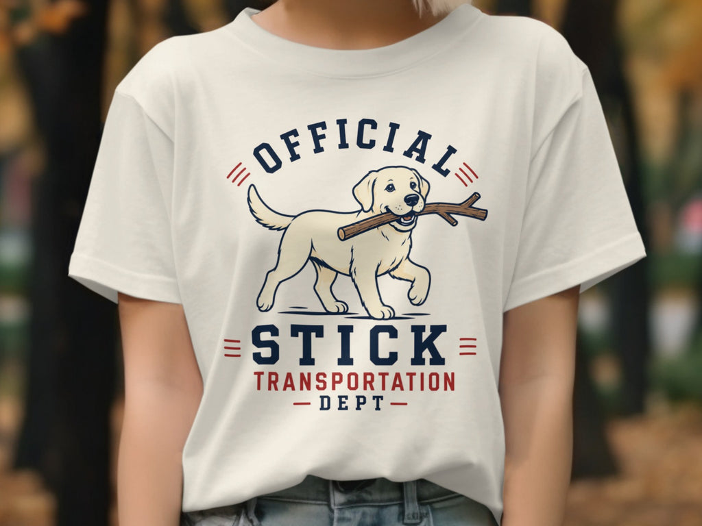 Cream t-shirt with white Labrador, stick in mouth, and text "OFFICIAL STICK TRANSPORTATION DEPT".