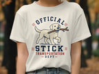 Cream t-shirt with white Labrador, stick in mouth, and text "OFFICIAL STICK TRANSPORTATION DEPT".