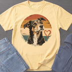 Yellow t-shirt with distressed dog and heart graphic, paired with jeans and hoodie.