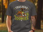 Boxer dog with stick and bandana, text "Trailhead Zoomies"