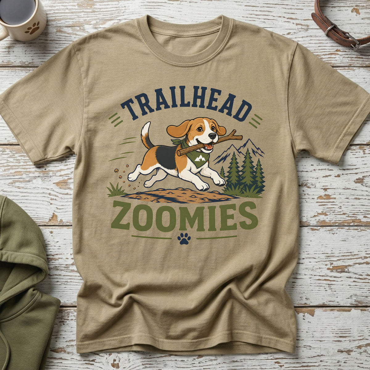 Beagle with stick on shirt reads "Trailhead Zoomies" with mountains and trees.