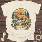 Dog Parent Social Club design with poodle in chair, trees, and sunset.