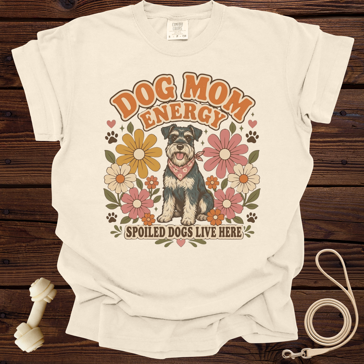 Cream t-shirt with retro graphic of dog, flowers, and text "Dog Mom Energy" and "Spoiled Dogs Live Here".