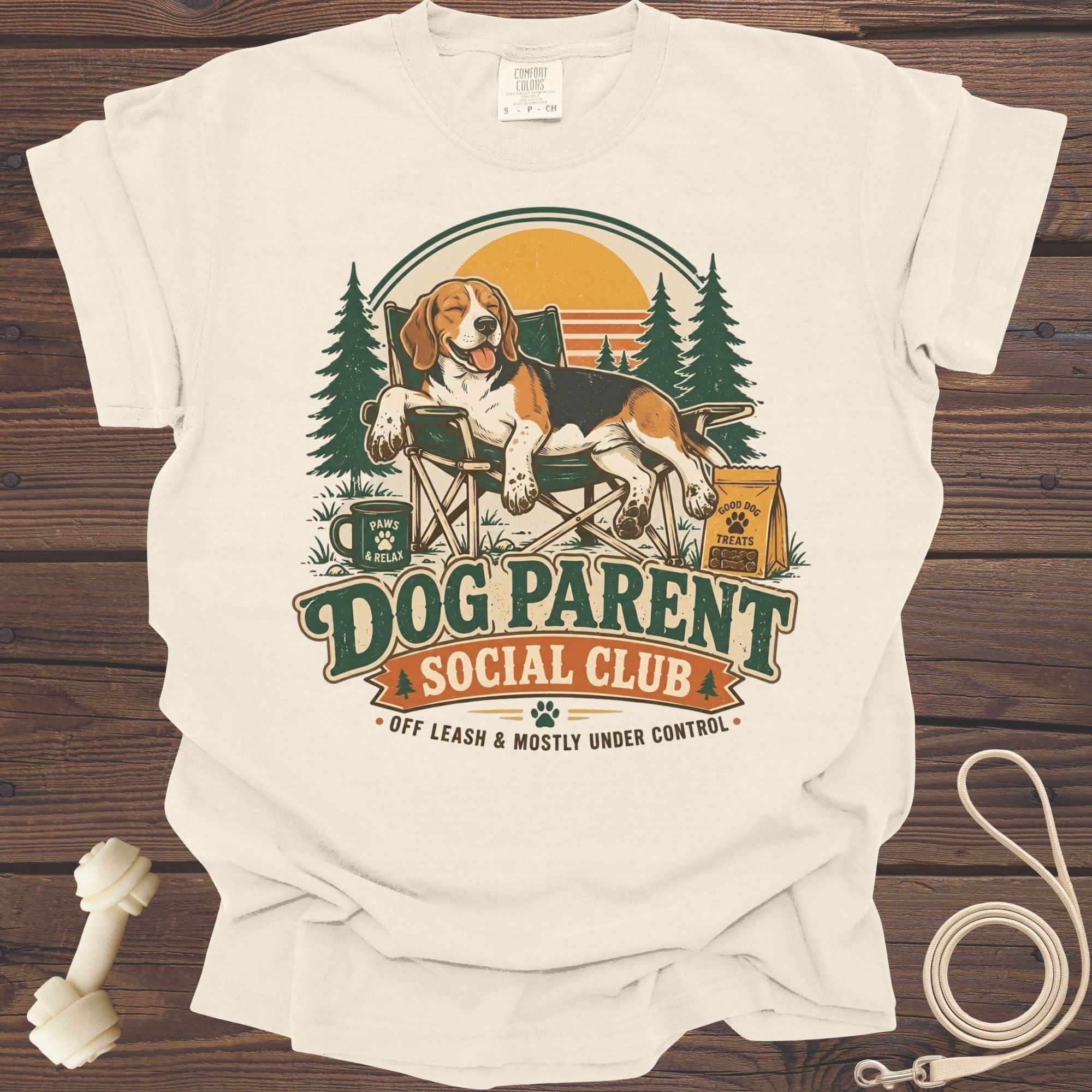 T-shirt with a beagle relaxing in a camping chair, text reads "Dog Parent Social Club."