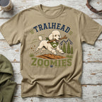 Poodle running with stick on dirt with "TRAILHEAD ZOOMIES" text.