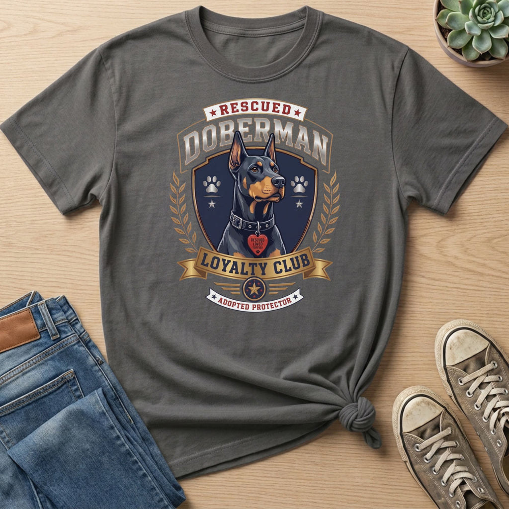 Grey t-shirt with rescued Doberman graphic, "Loyalty Club" and "Adopted Protector" text.
