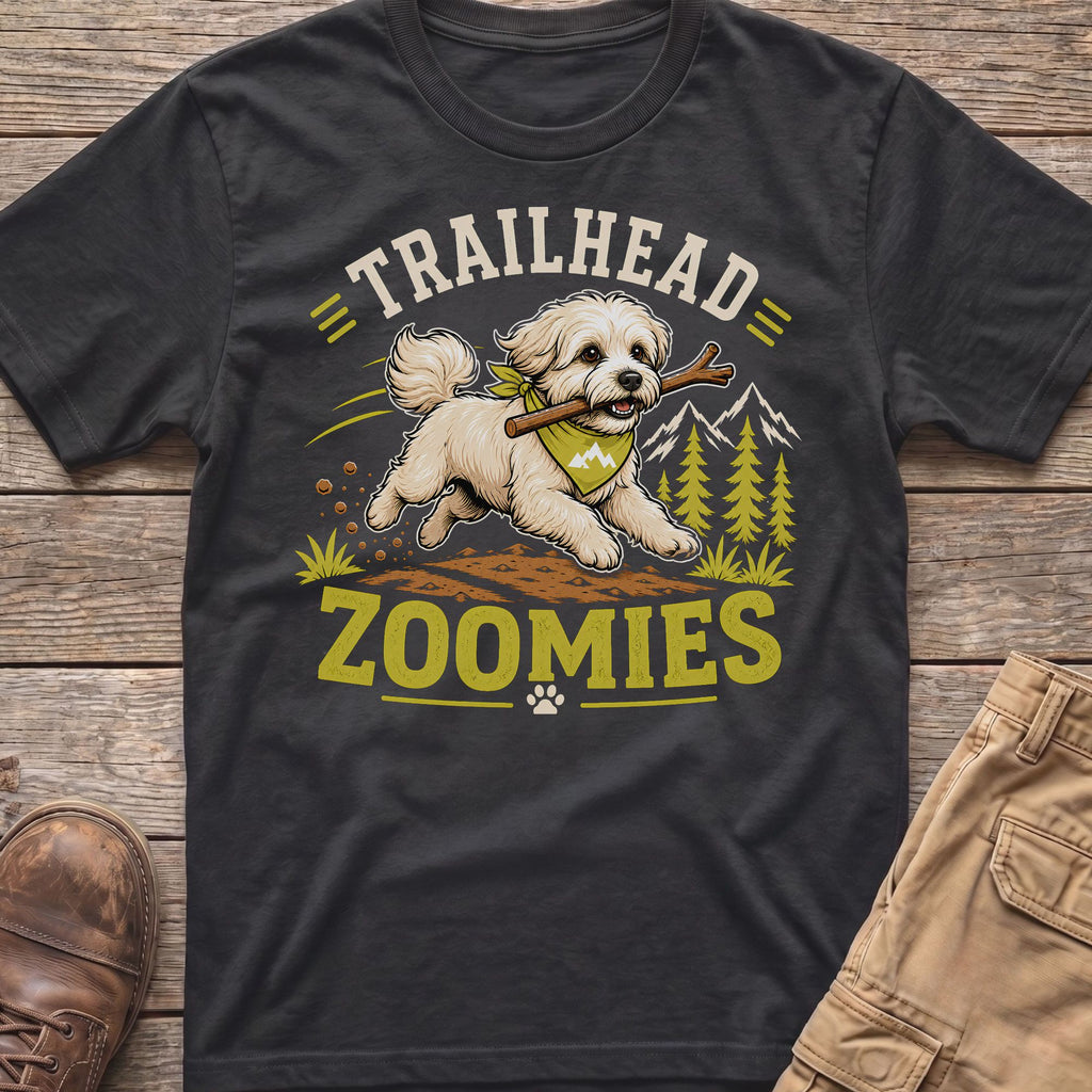 White dog with stick on t-shirt, text "TRAILHEAD ZOOMIES", mountains, trees