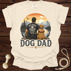 Cream t-shirt with "Dog Dad" graphic of man and dog in mountains.