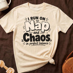 Cream t-shirt with black text reading "I Run on Nap and Chaos in perfect balance".