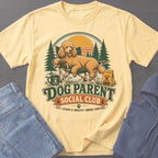 Yellow t-shirt with graphic of poodle relaxing in chair and text "Dog Parent Social Club".