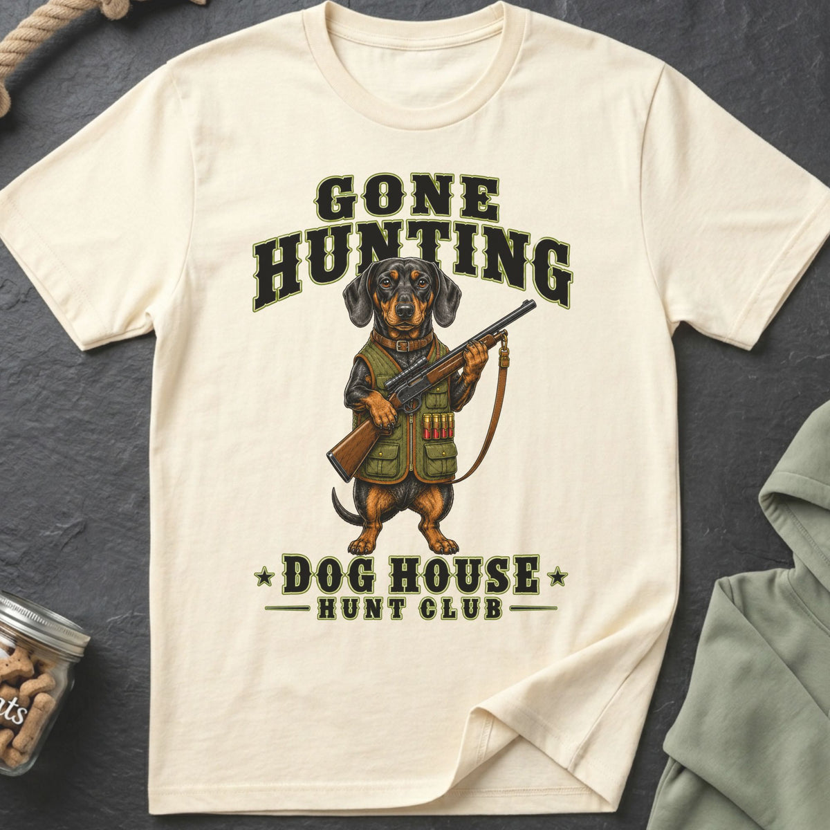 Dachshund in hunting gear holding rifle, text says "Gone Hunting Dog House Hunt Club".