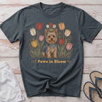 Yorkshire Terrier sitting among colorful tulips with "Paws in Bloom" text.