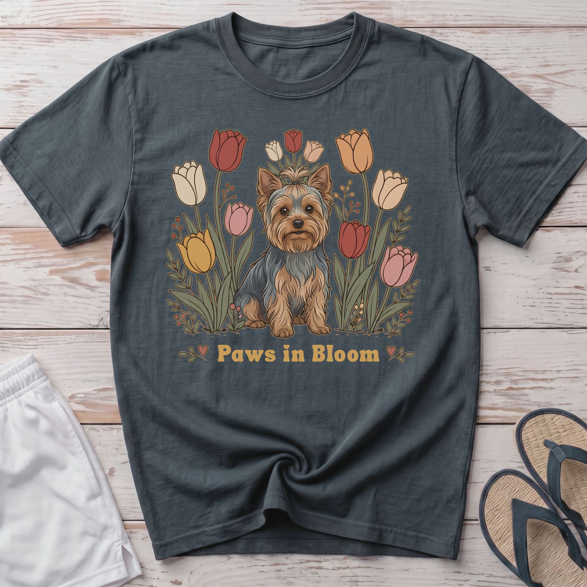 Yorkshire Terrier sitting among colorful tulips with "Paws in Bloom" text.