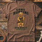 Golden retriever wearing hunting vest and holding rifle with "Gone Hunting" and "Dog House Hunt Club" text.
