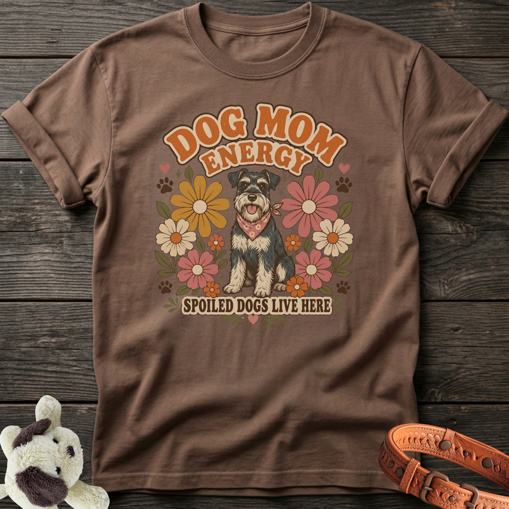 Brown t-shirt with retro floral design featuring a schnauzer and text "Dog Mom Energy Spoiled Dogs Live Here".