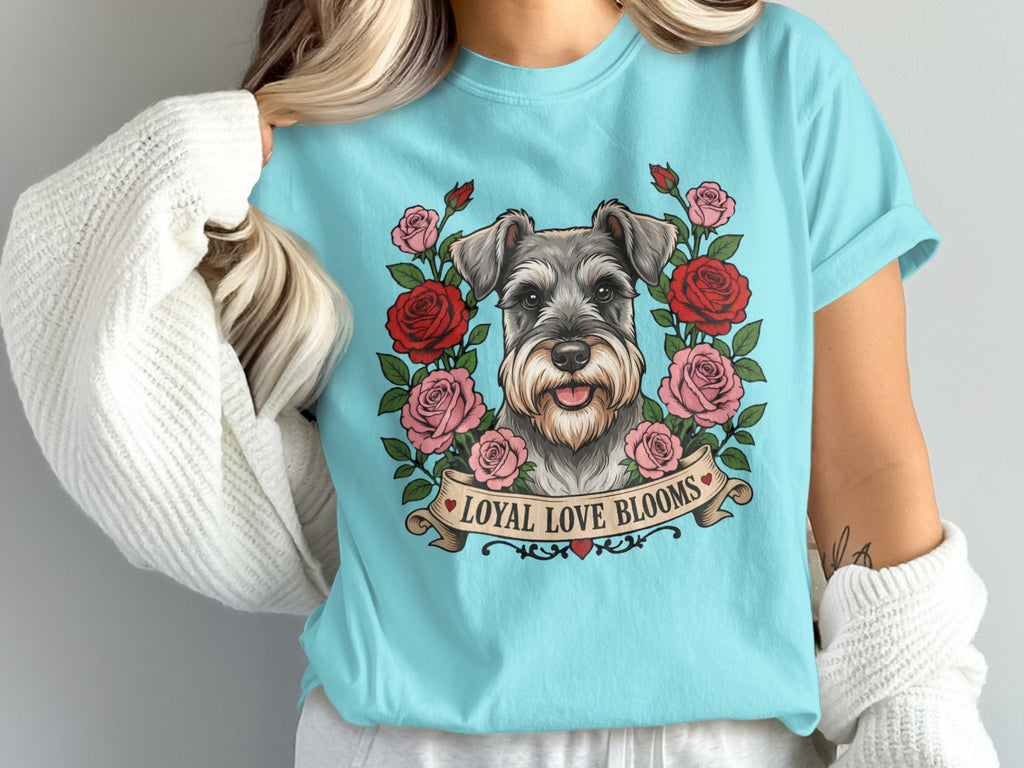 Schnauzer portrait surrounded by roses on a light blue t-shirt with text "Loyal Love Blooms."