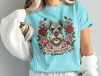 Schnauzer portrait surrounded by roses on a light blue t-shirt with text "Loyal Love Blooms."