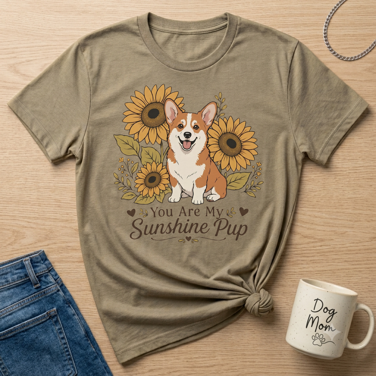 Corgi surrounded by sunflowers on a t-shirt with text "You Are My Sunshine Pup."