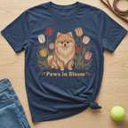 Navy t-shirt with illustration of a Pomeranian dog and tulips, text "Paws in Bloom".