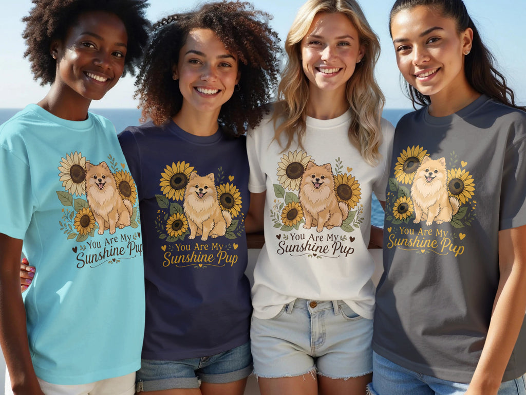 Four women model t-shirts with a Pomeranian and sunflowers graphic, reading "You Are My Sunshine Pup".