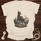 Cream t-shirt with a Doberman wearing a backpack in a mountain landscape graphic.