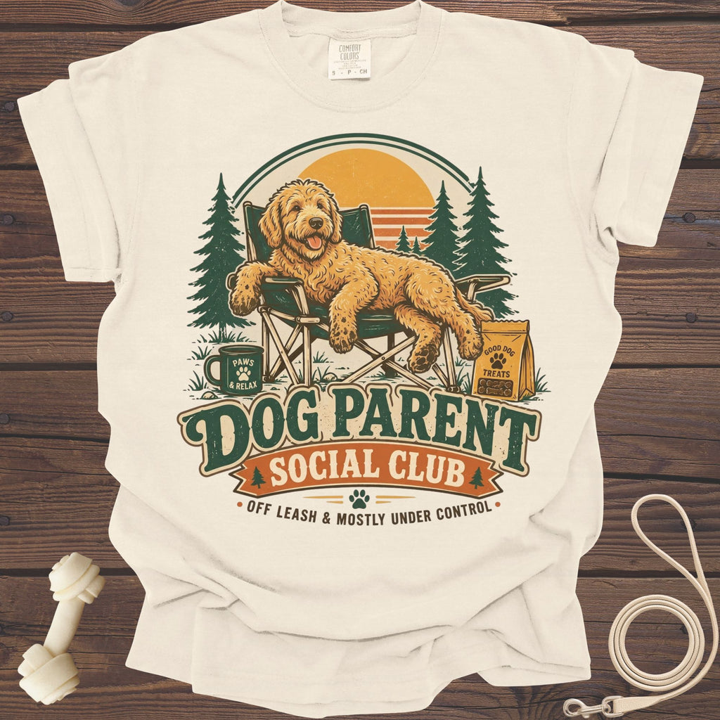 Goldendoodle relaxing in a camping chair with text "Dog Parent Social Club".