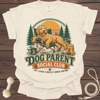Goldendoodle relaxing in a camping chair with text "Dog Parent Social Club".