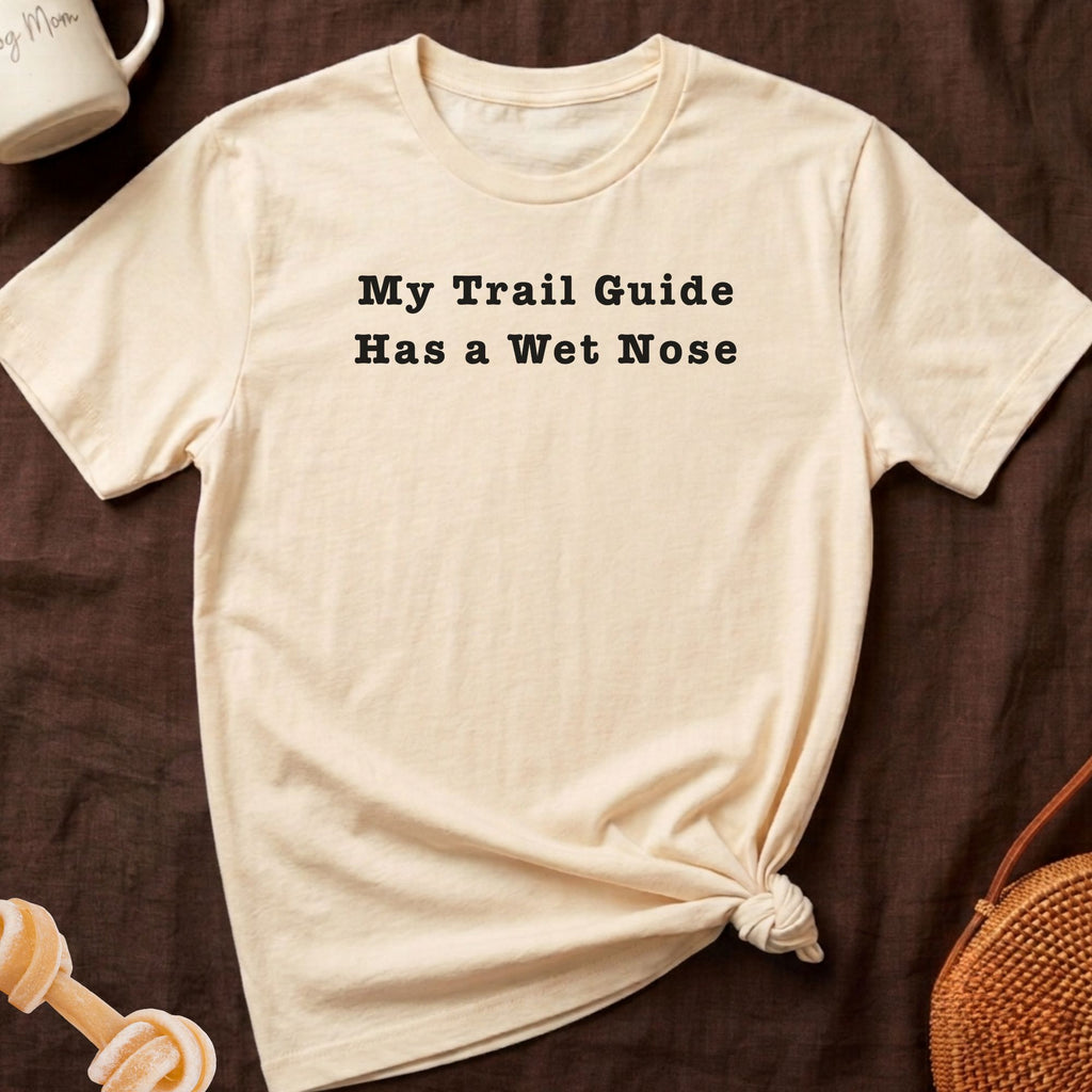 Cream t-shirt with black text that reads "My Trail Guide Has a Wet Nose."