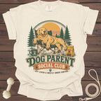 Graphic t-shirt with a Golden Retriever relaxing in a camping chair with "Dog Parent Social Club" text.