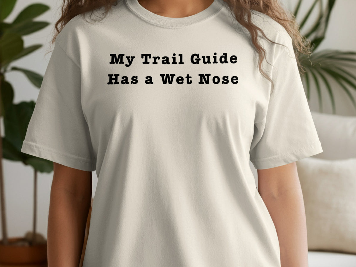 Light beige t-shirt with black text that reads "My Trail Guide Has a Wet Nose".