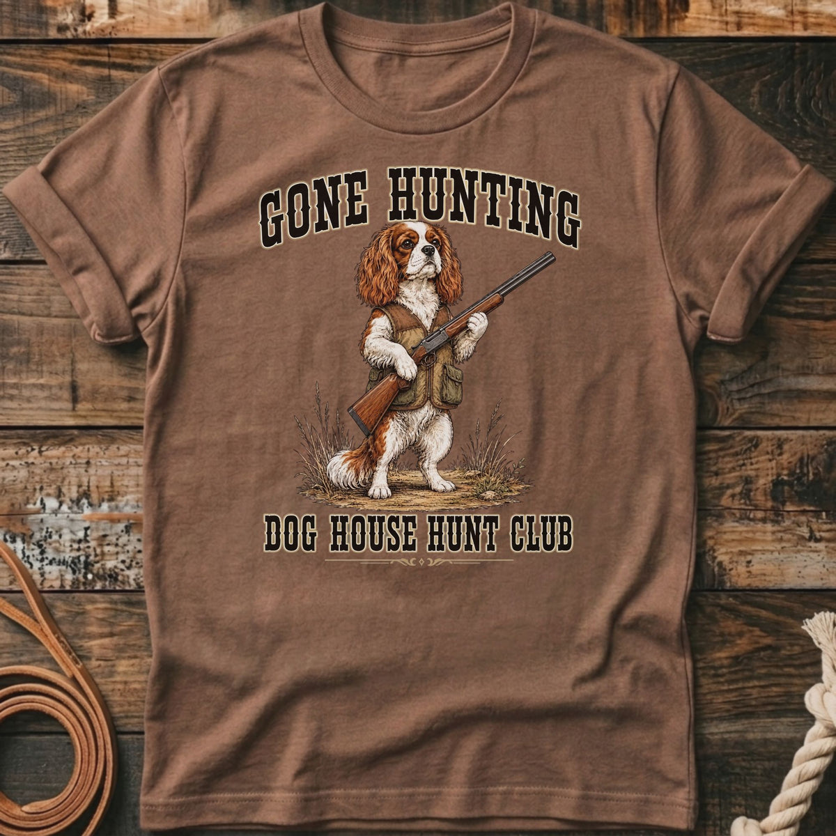 Brown t-shirt with "Gone Hunting Dog House Hunt Club" text and dog holding a rifle.