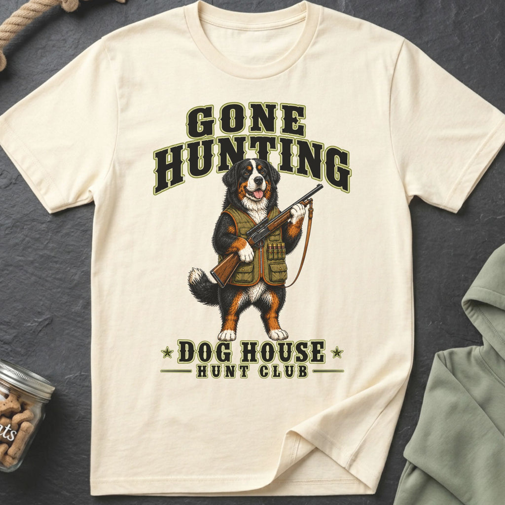 Bernese Mountain Dog wearing hunting vest, holding rifle, text "Gone Hunting Dog House Hunt Club".