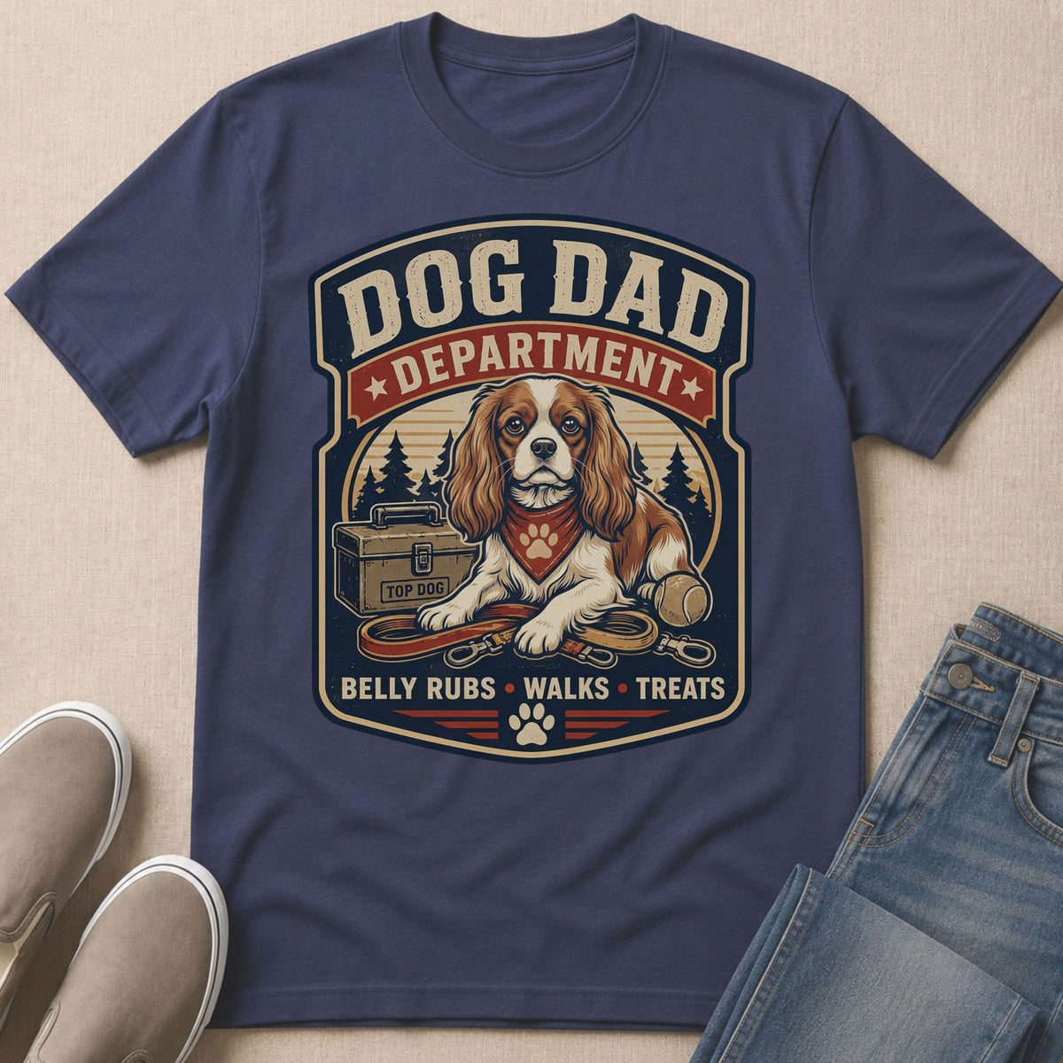 Dog Dad Department graphic with King Charles Spaniel, leash, ball, and toolbox.